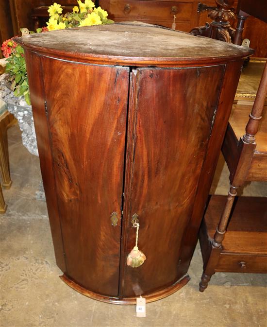 A George III mahogany bow-fronted hanging corner cupboard, Width 61cm